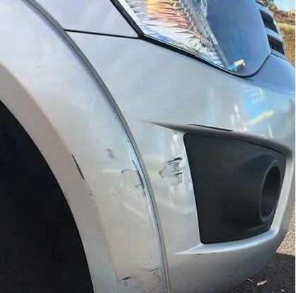 Silver front fender before the repair