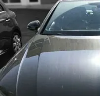 Dark car bonnet before the repair